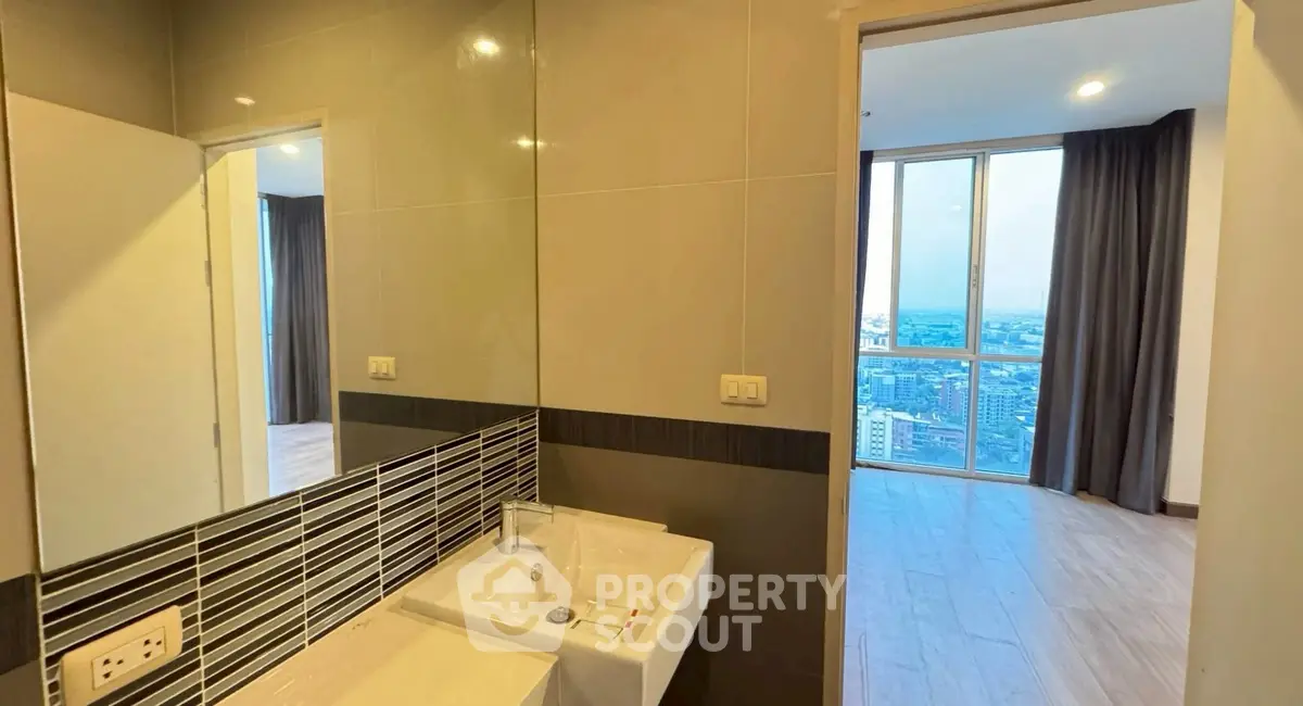 Modern bathroom with city view from adjacent room