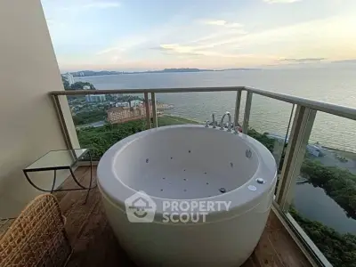 Luxurious balcony with stunning ocean view and private outdoor bathtub.