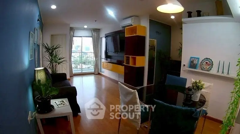 Modern living room with stylish decor and balcony view in a cozy apartment.