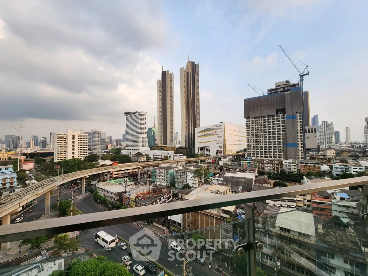 Stunning cityscape view from a high-rise balcony showcasing urban skyline and modern architecture.