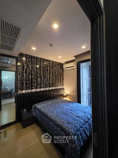 Modern bedroom with stylish decor and cozy ambiance in a contemporary apartment.
