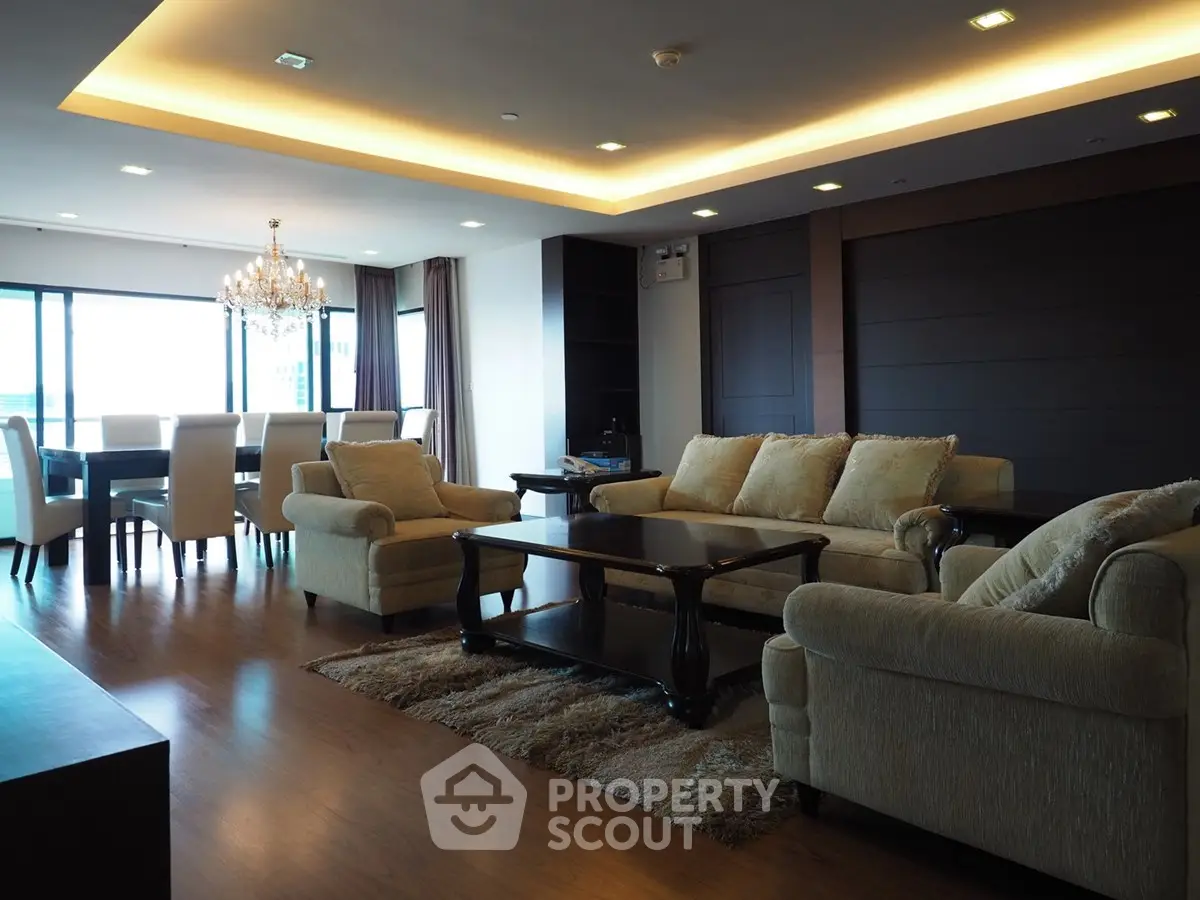 Luxurious living room with elegant chandelier and spacious dining area
