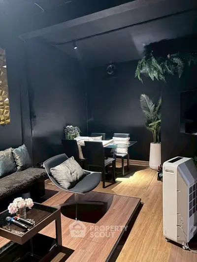 Stylish modern living room with sleek black decor and cozy seating area