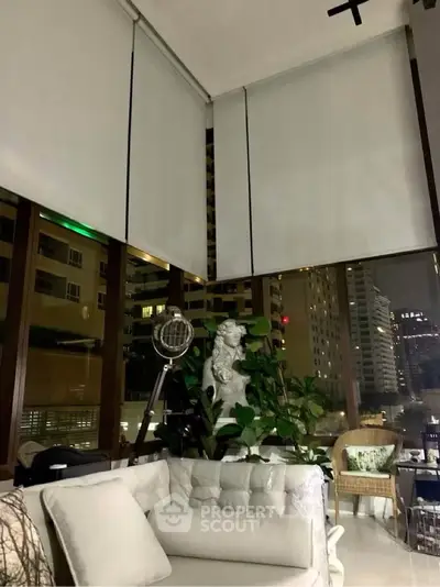 Luxurious living room with floor-to-ceiling windows and city view, featuring elegant decor and plush seating.