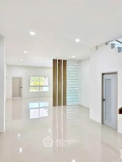 Spacious modern living room with large windows and sleek design elements