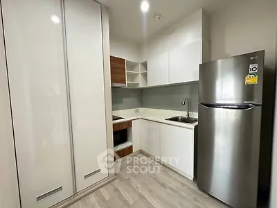 Modern kitchen with sleek appliances and ample storage space.