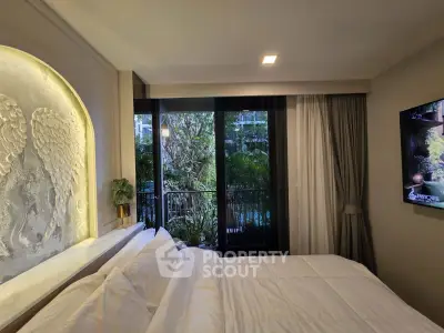 Luxurious bedroom with elegant decor and balcony view of lush greenery, perfect for serene living.