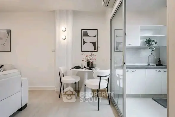 Modern open-plan living and dining area with sleek kitchen design.