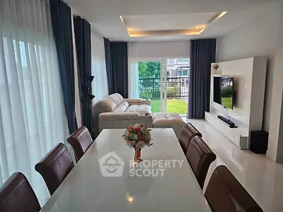 Spacious modern living room with elegant dining area and garden view, perfect for family gatherings.
