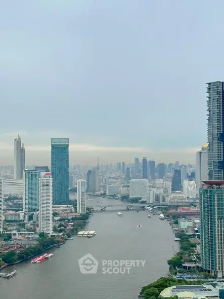 Stunning cityscape view of a river surrounded by modern skyscrapers and lush greenery.