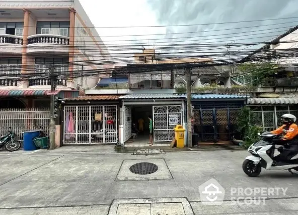 Charming urban street view with residential buildings and motorbike, ideal for city living.