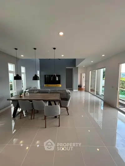 Spacious modern living room with sleek design and abundant natural light, perfect for family gatherings.