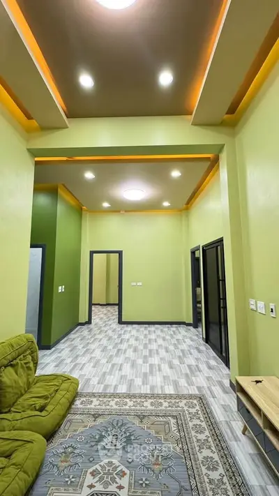 Modern living room with stylish ceiling lights and green accents