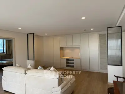 Spacious living room with modern design and cozy seating area, perfect for relaxation and entertainment.