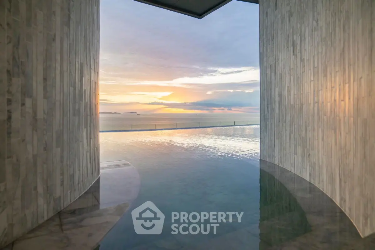 Stunning infinity pool with breathtaking ocean view at sunset, perfect for luxury living.