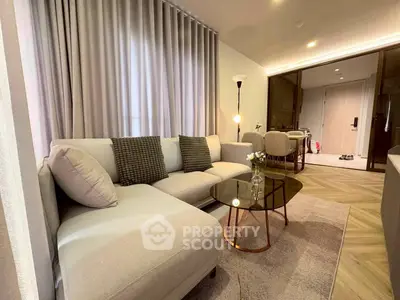 Modern living room with elegant decor and cozy seating area in a stylish apartment.
