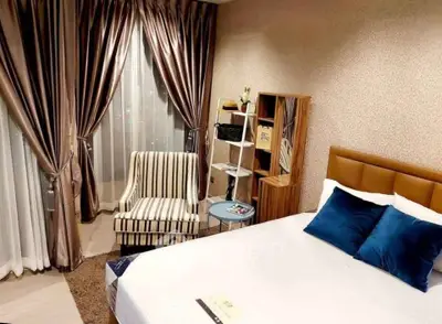 Luxurious bedroom with elegant decor and plush furnishings in a modern apartment.