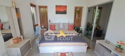 Modern bedroom with stylish decor and natural light, featuring a cozy bed and elegant furnishings.