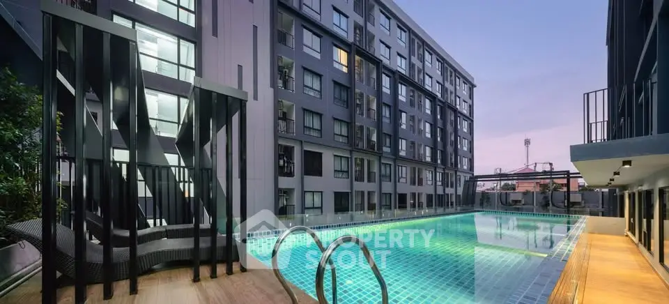 Modern apartment building with illuminated outdoor pool at dusk, perfect for urban living.