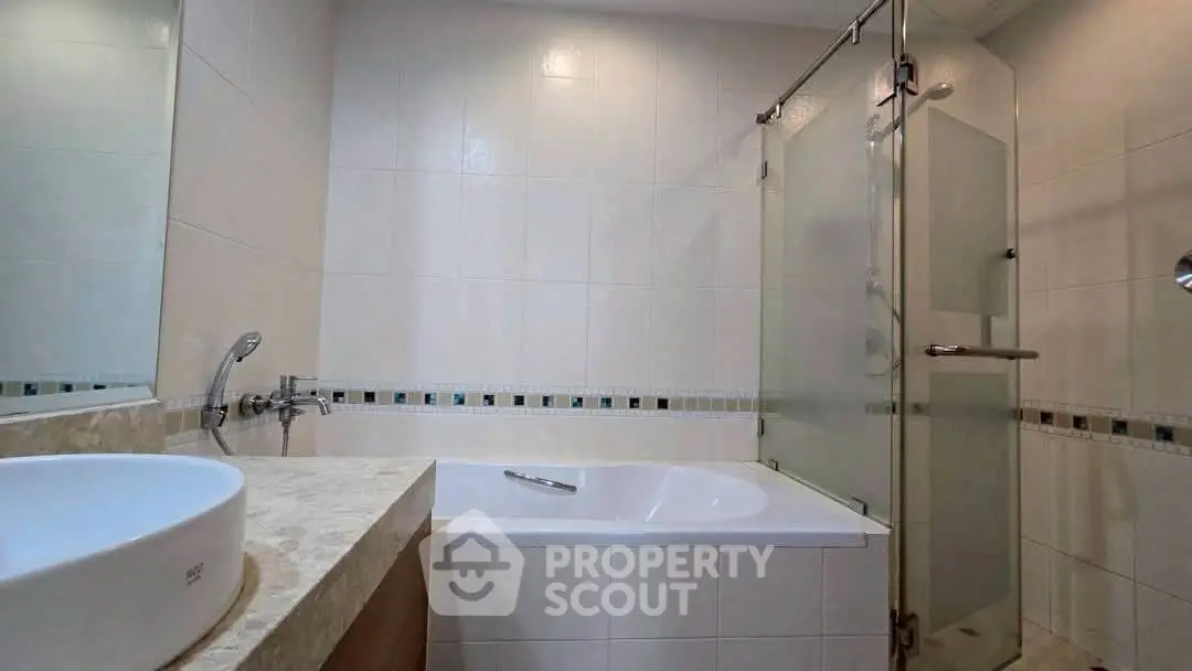 Modern bathroom with sleek bathtub and glass shower enclosure