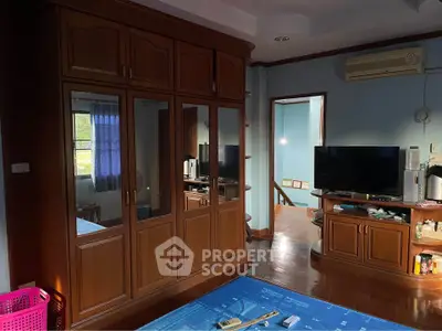 Spacious living room with wooden furniture and modern amenities