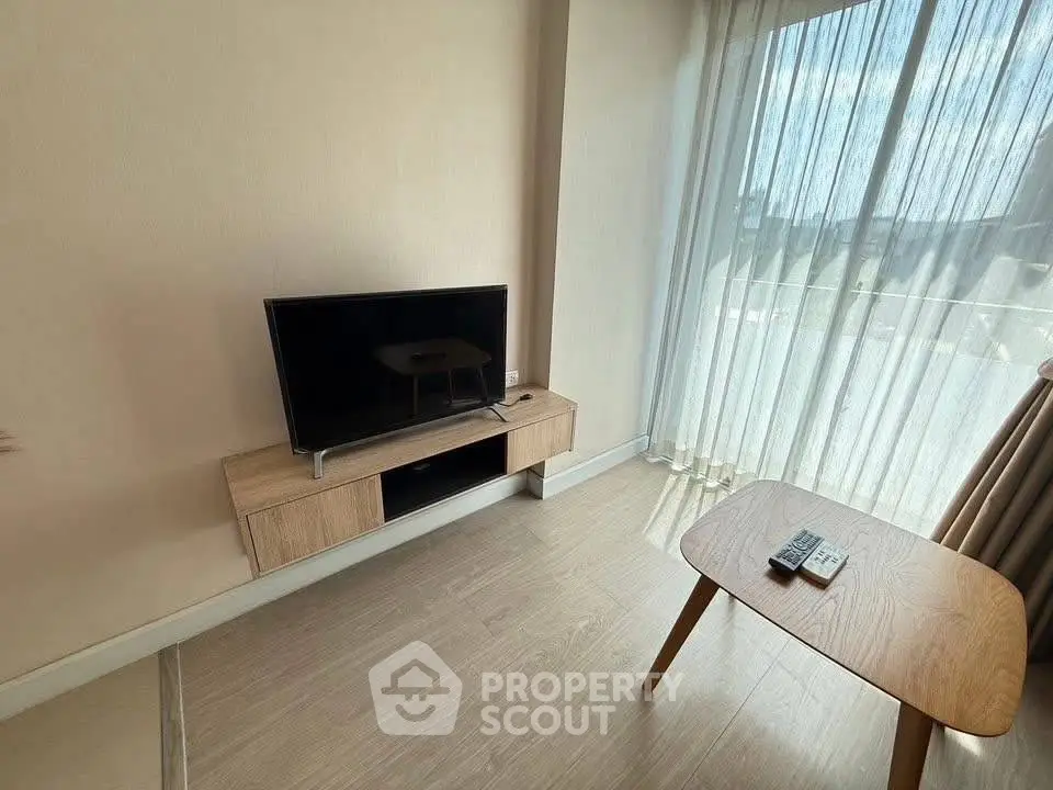 Modern living room with sleek TV setup and natural light