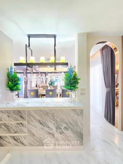 Luxurious modern interior with elegant lighting and marble accents in a stylish open layout.