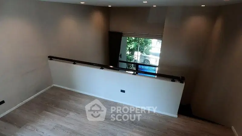 Spacious interior with modern wooden flooring and natural light