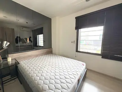 Modern bedroom with large window and stylish decor in urban apartment