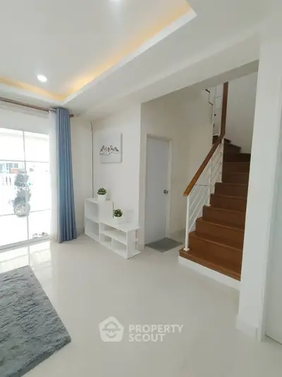 Modern interior with staircase and natural light, perfect for stylish living.