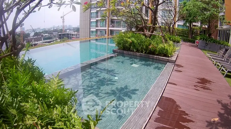 Luxurious rooftop infinity pool with stunning city views and lush greenery.