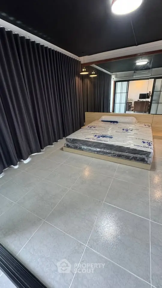 Modern bedroom with sleek design and large windows for natural light.