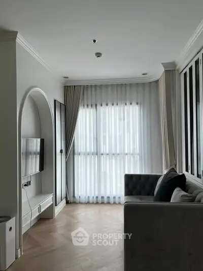 Modern living room with elegant decor and large window drapes