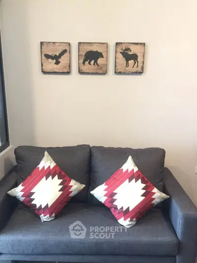 Cozy living room with stylish gray sofa and decorative animal art