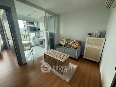 Modern living room with open kitchen and stylish decor in urban apartment.