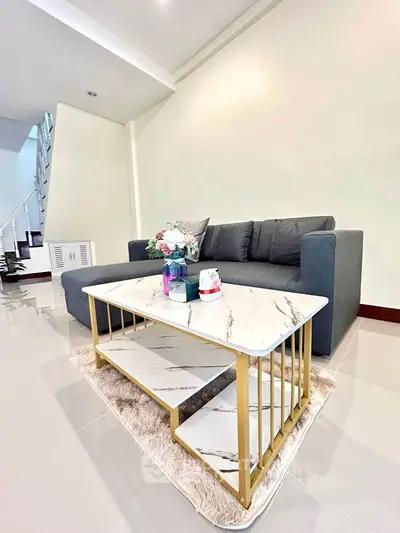 Modern living room with sleek sofa and elegant marble coffee table