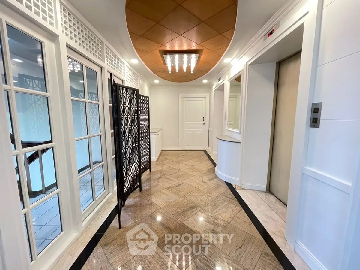 Elegant building entrance with modern elevator and stylish decor