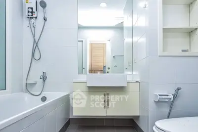 Modern bathroom with sleek fixtures and a bathtub in a contemporary home.