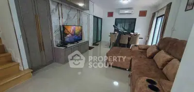 Spacious living room with plush brown sofa and modern entertainment setup