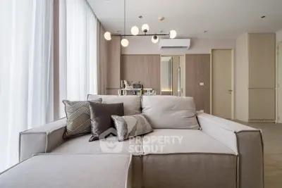 Modern living room with stylish sofa and elegant lighting in a contemporary apartment.