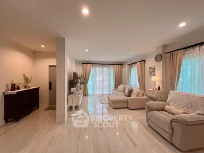 Spacious and elegant living room with modern decor and ample natural light.