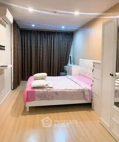 Cozy bedroom with modern decor and ample natural light