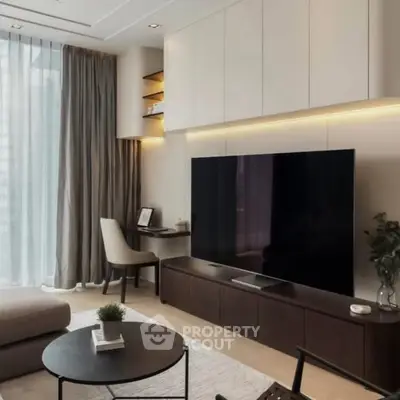 Modern living room with large TV, elegant furniture, and natural light