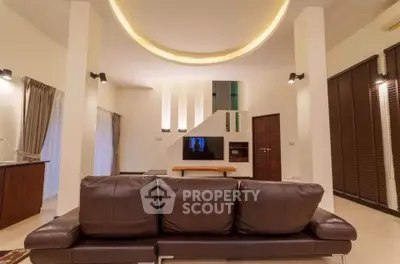 Spacious modern living room with elegant lighting and leather sofa