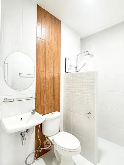 Modern minimalist bathroom with white tiles and wooden accent wall