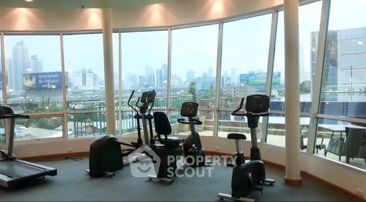 Spacious gym with city view and modern exercise equipment