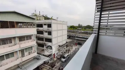 Urban balcony view with cityscape and modern architecture, ideal for city living enthusiasts.