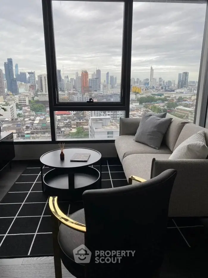 Modern living room with stunning city view from high-rise apartment window.