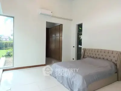 Spacious bedroom with garden view and elegant bed