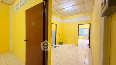 Spacious interior with vibrant yellow walls and tiled flooring, ideal for creative customization.